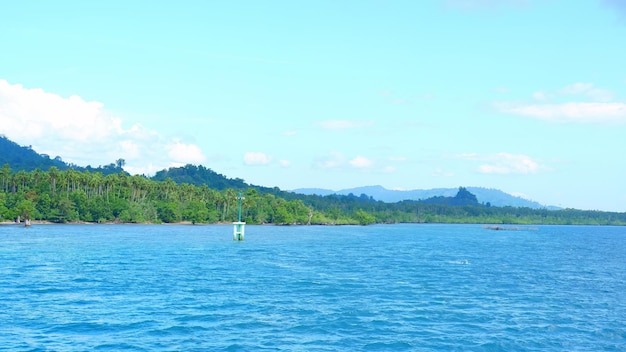 The blue waters of the lake are a sign that says the name of the island.