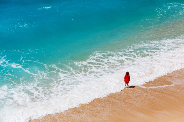 Blue wave on the beach. Blur background and sunlight spots. Peaceful natural background.