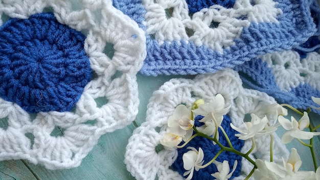 Blue white crochet elements and orchid Crochet texture place for an inscription adapted for mobile