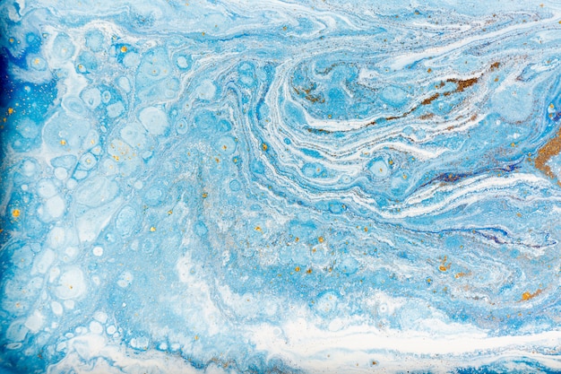 Blue and white marbling  with gold glitter. Marble liquid texture.