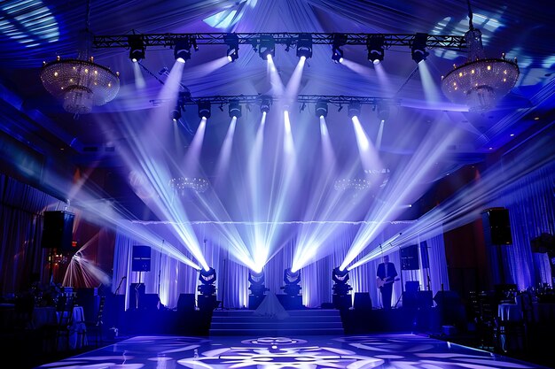 Photo blue and white stage setup with chandeliers for wedding reception