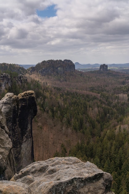 Blue window in the clouds above the stones of saxon Switzerland