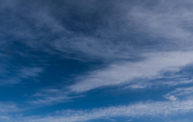 Blue winter sky and light clouds. Windy weather. High quality photo.