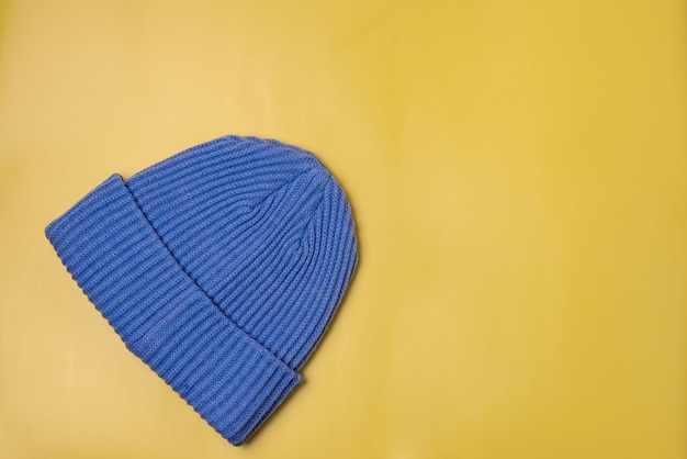 Blue Woolen Hat on Yellow Background Horizontal