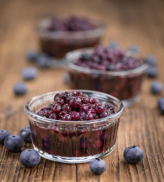 Blueberries preserved on wooden background selective focus