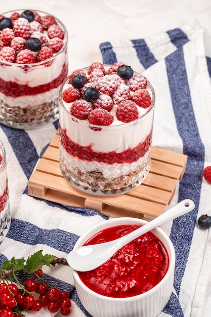 Blueberries and raspberries yogurt parfait with granola in glass Concept of weight loss healthy eating healthy dessert food