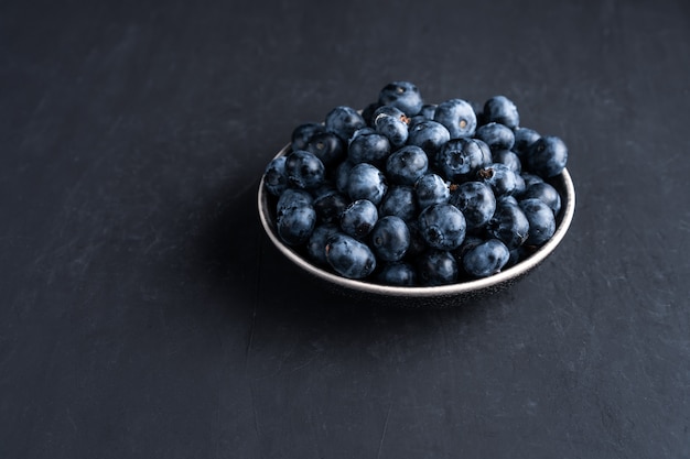 Blueberry antioxidant organic superfood in ceramic bowl concept for healthy eating and dieting nutrition