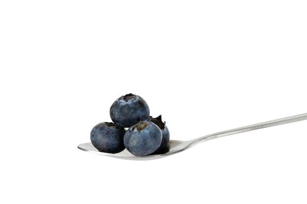 Blueberry on a dessert spoon on a white background.