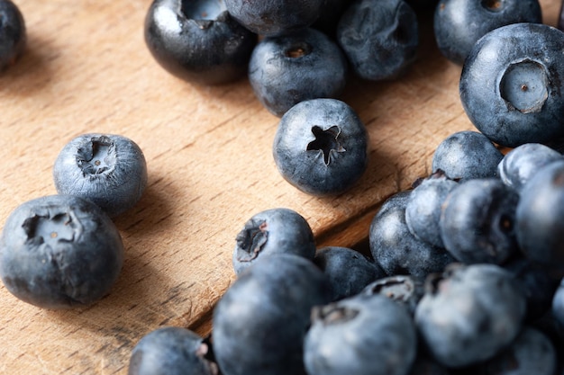 Blueberry Fresh blueberries on a wooden table closeup Sprinkle blueberries Scattered blueberries