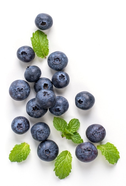 Blueberry fruit top view isolated on a white background, flat lay overhead layout with mint leaf, healthy design concept.