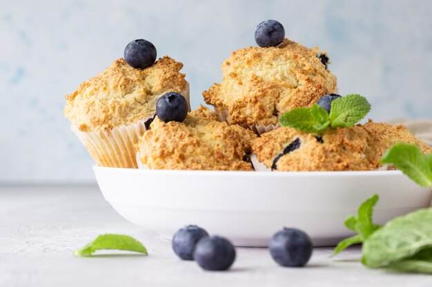 Blueberry muffins with fresh berries and mint