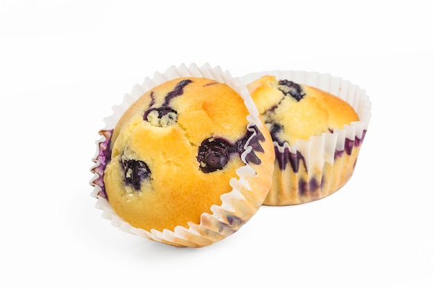 Blueberry muffins with powdered sugar and fresh berries