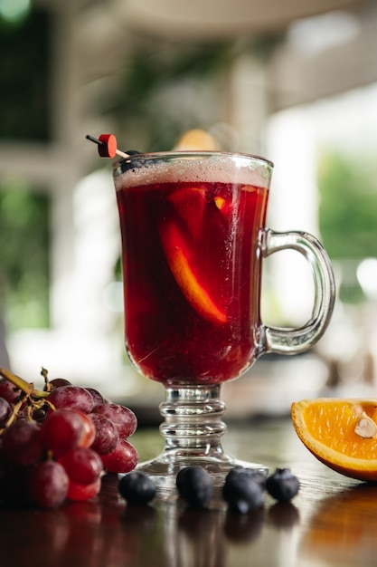 blueberry mulled wine with orange and grape on the table in restaurant