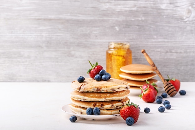 Blueberry pancakes served with honey