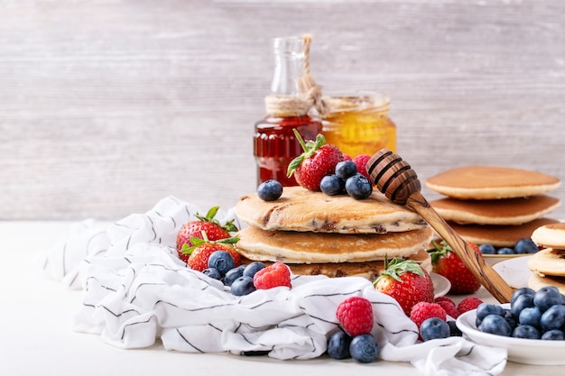 Blueberry pancakes served with honey