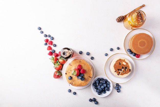 Blueberry pancakes served with honey