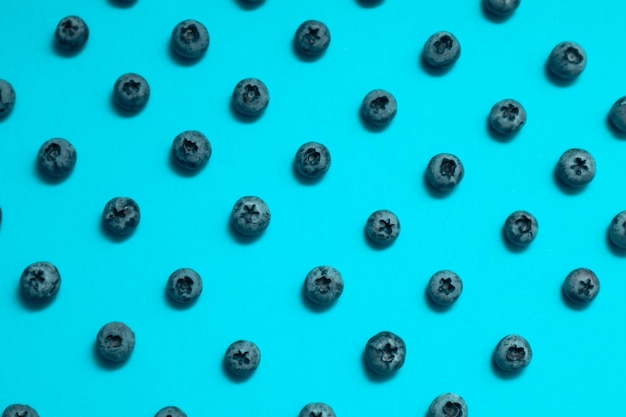 Photo blueberry pattern on a blue background viewed from above top view