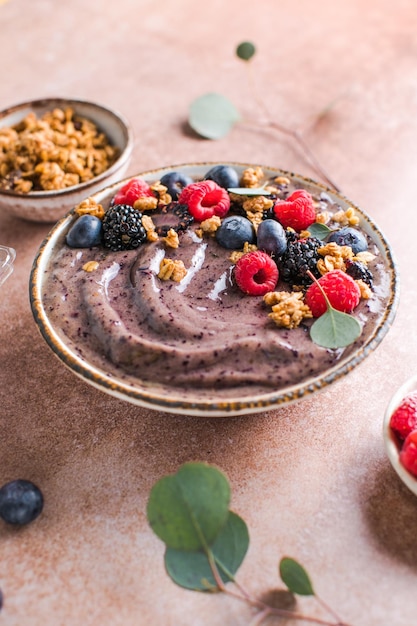 Blueberry Smoothie Bowl with Granola Banana and Chia Seeds Healthy Food Vegan or Vegetarian Diet Food Concept Bright Background