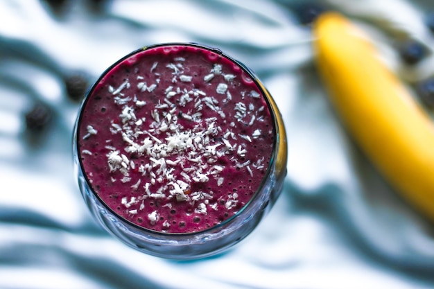 Blueberry smoothie with coconut healthy eating recipe styled concept