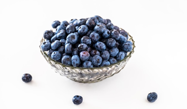 Blueberry in vintage glass plate on white table