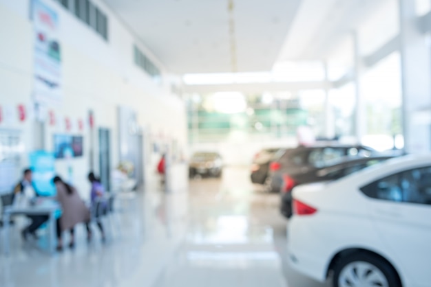 Blur the background of the car and Showroom at blurred in workplace or abstract background of shallow office depth of focus.