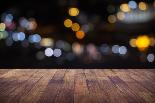 Blur cafe restaurant or coffee shop empty of dark wood table with blurred light bokeh abstract background.