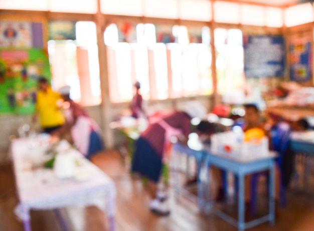 blur kids and teacher in the classroom for background usage.