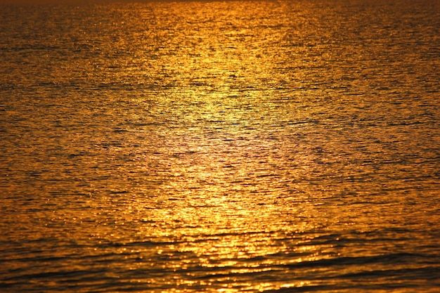 Blur sun light impact on sea reflex golden light abstract nature background