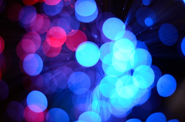 Blurred abstract pink and blue bokeh lights.