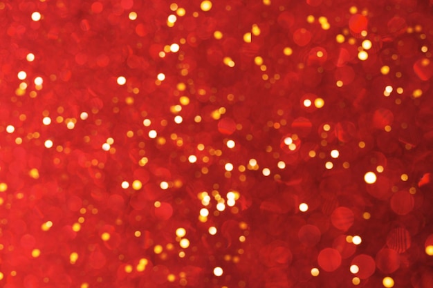 Blurred abstract red background with bokeh, defocused many lights. Holiday or christmas concept.