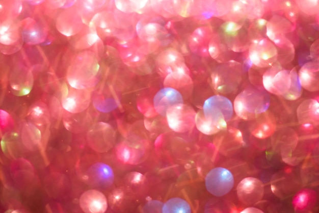 Blurred abstract red glitter bokeh defocused lights Holiday and Valentines day concept