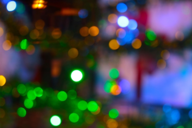 Blurred background Bright lights of the Christmas tree