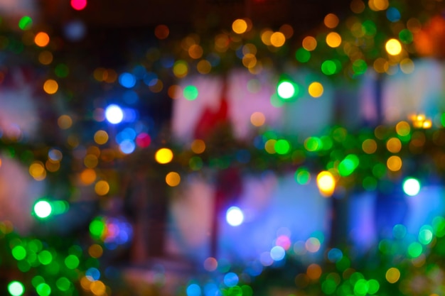 Blurred background bright lights of the decorated city on the eve of Christmas and New Year