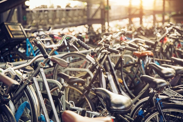 Blurred background of different bicycles in the parking lot rainy day Parked bicycles in Amsterdam