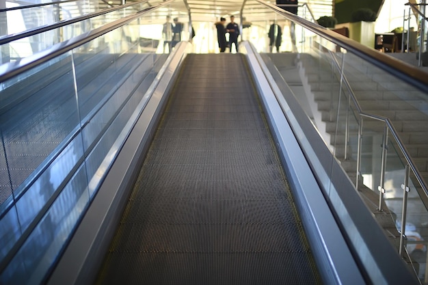 blurred background metro escalator / light blue background movement city infrastructure subway