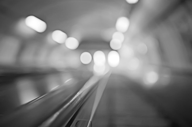 blurred background metro escalator / light blue background movement city infrastructure subway