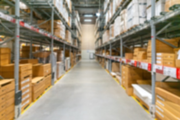 Blurred background of the warehouse. Boxes with goods on the shelves.