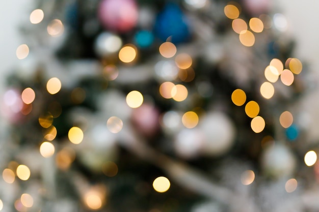 Blurred background with blinking lights of christmas tree