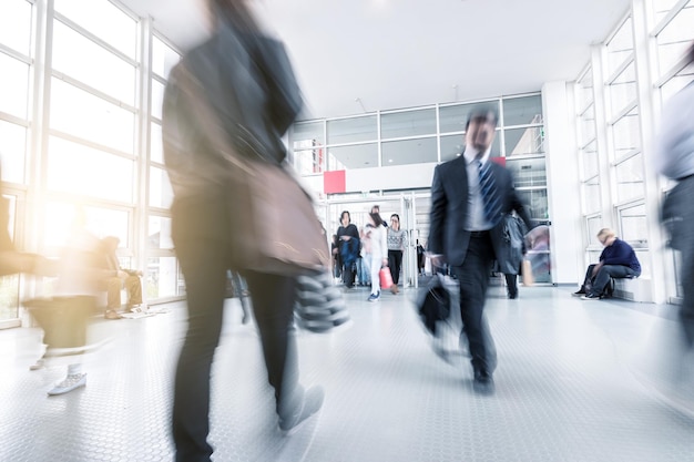 Blurred business people at a trade fair entrance