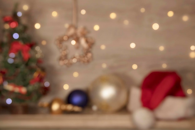 blurred Christmas background with Christmas toys garland gold lights star and Santa Claus hat