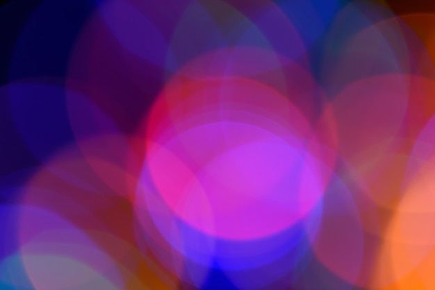 Blurred colorful circular facular on dark background.