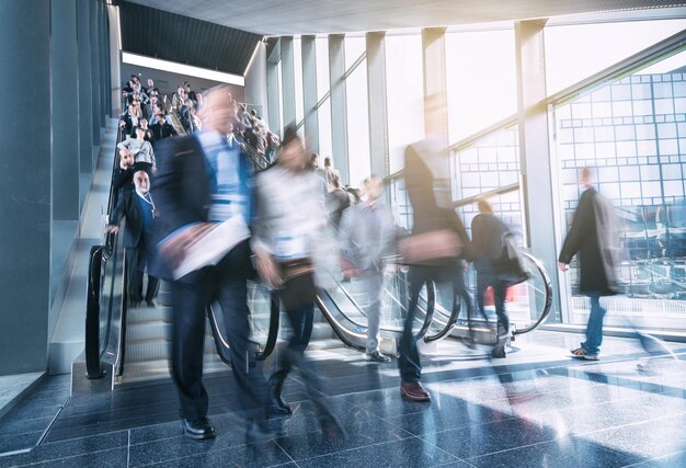 Blurred commuters rushing on escaltors in a  tradeshow. ideal for websites and magazines layouts