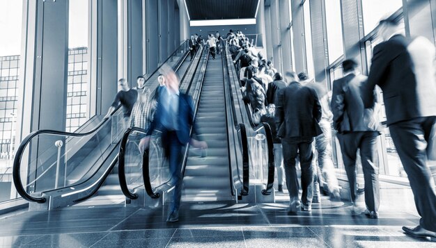 Blurred commuters rushing on escaltors at a tradeshow. ideal for websites and magazines layouts