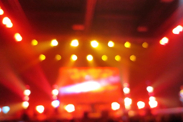 Blurred of concert lighting with joyful people. Abstract background concept.