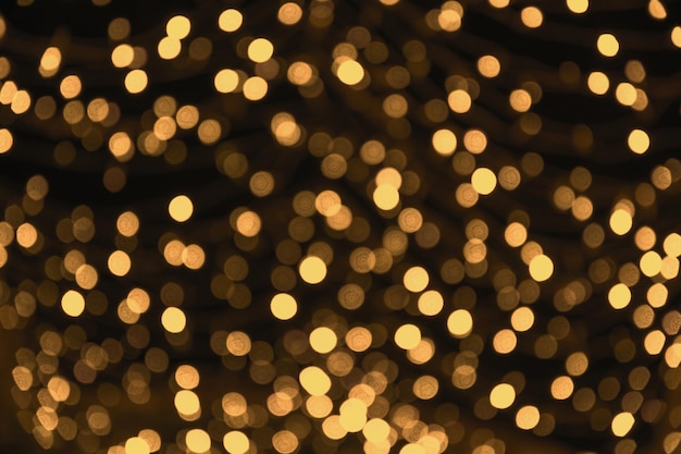 Blurred gold garland city night light blur bokeh defocused background christmas abstract