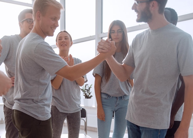 Blurred image of a group of young people sitting in a circle