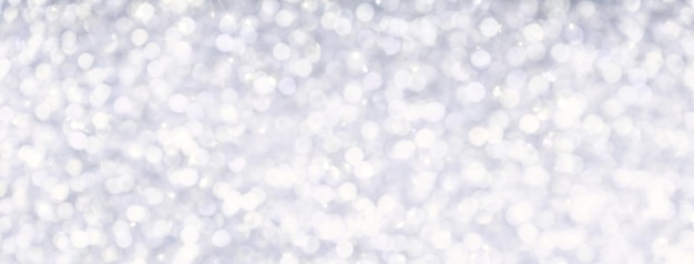 Blurred light silver sparkling background from small sequins macro Brilliant and diamond pearl white defocused backdrop