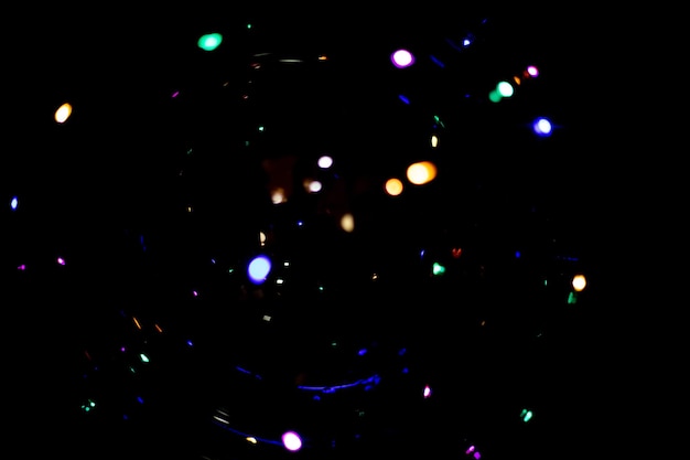 Blurred lights beautiful bokeh on a black background glitter of the night city