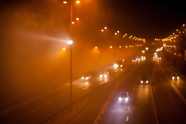 Blurred motion picture in Kyiv at night in the fog Blurred image of Kyiv's evening traffic