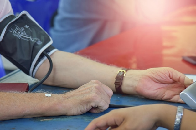 Blurred of patient arm during blood pressure measuring at medical consultation Mobile medical unit